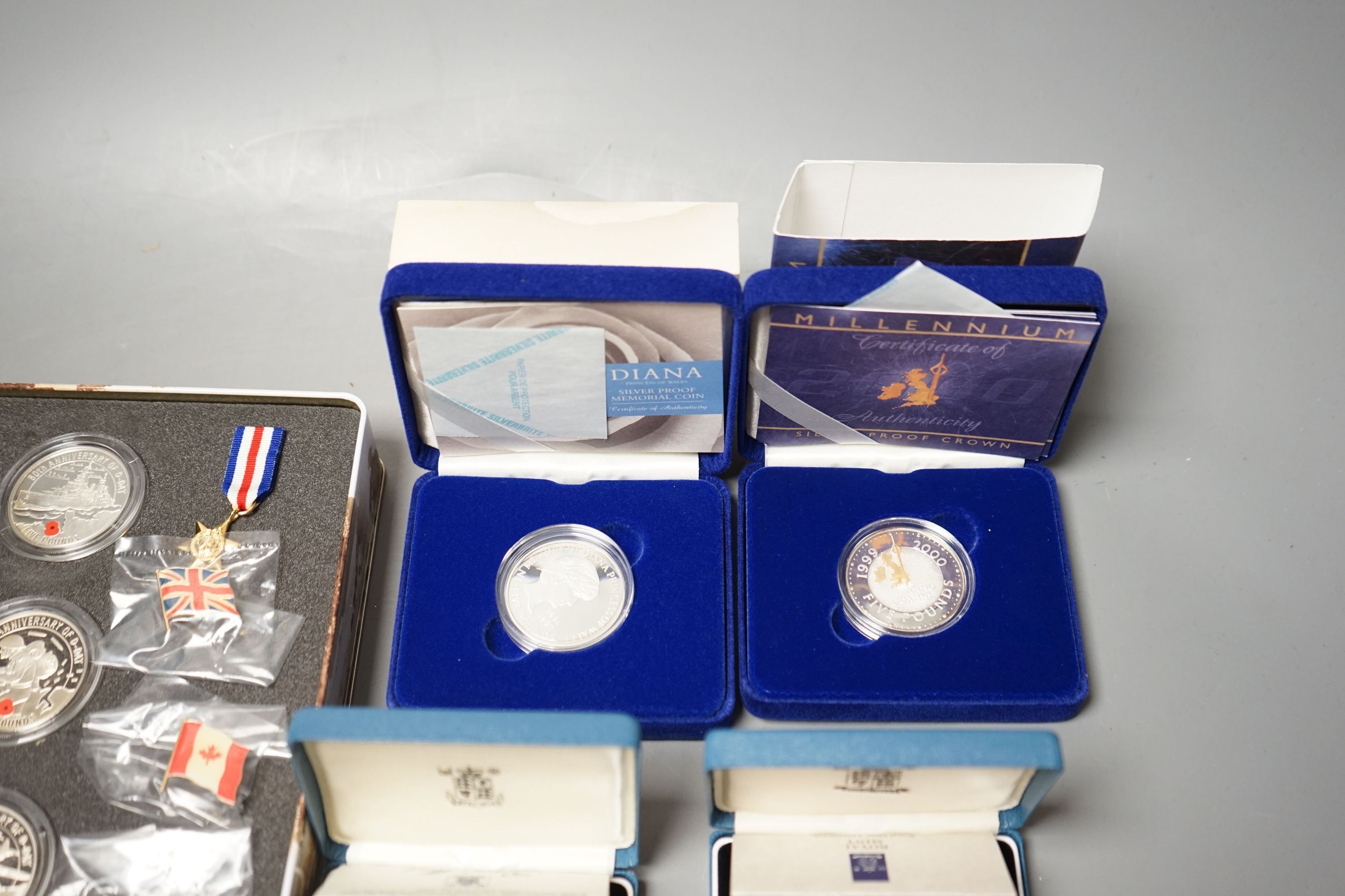 Cased Royal Mint UK proof coins – a Diana Memorial silver coin, a Millennium £5, a D-day 3 coin silver medal set, a 1992 two coin 10p set and a 1989 two coin £2 set